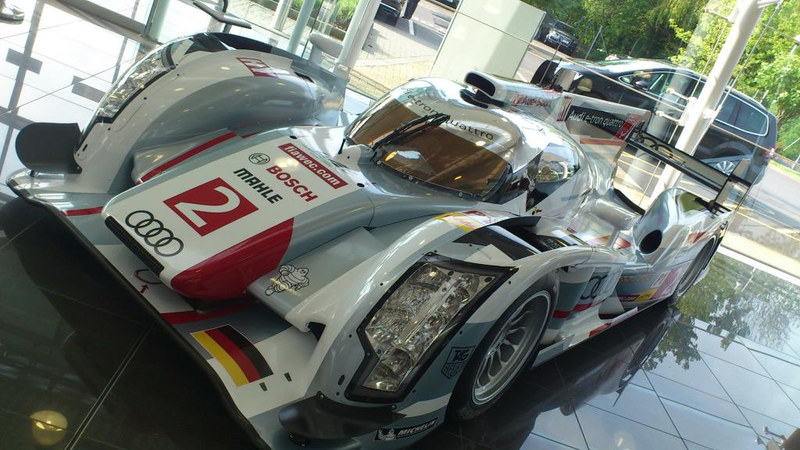 Illustration for article titled Audi R18 E-Tron (was) parked at Volkswagen Financial Services lobby